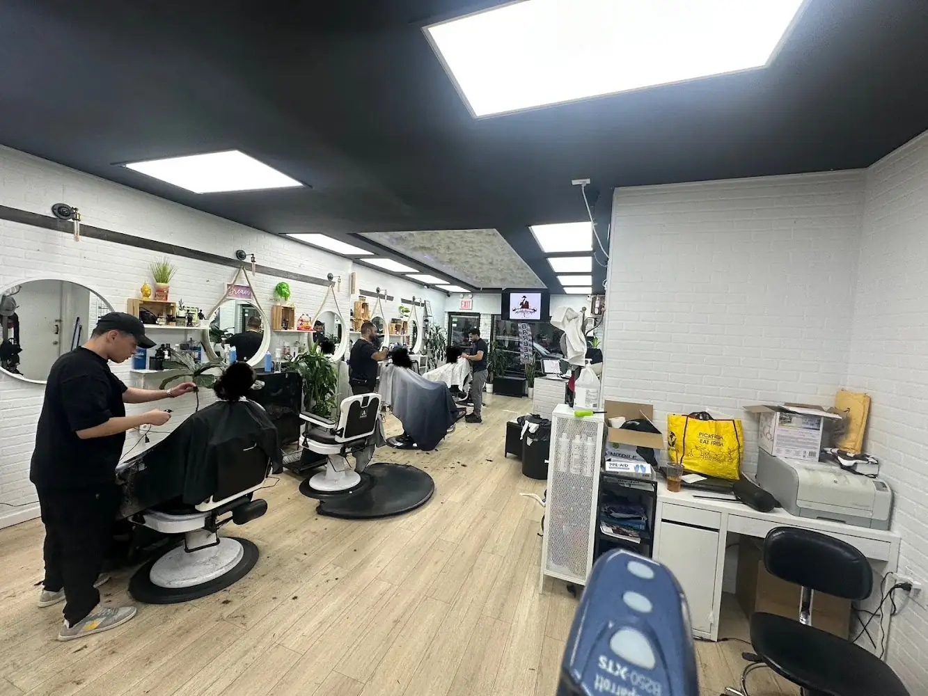 Barbershop interior with styling stations at DREAM Barbershop